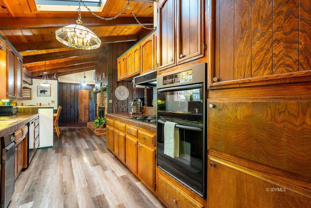 25580 Fir Street Idyllwild, CA 92549 - Photo 17 of 48 a kitchen with stainless steel appliances a stove and a refrigerator