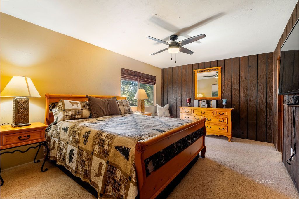 25580 Fir Street Idyllwild, CA 92549 - Photo 20 of 48 a bed room with a bed and a chandelier