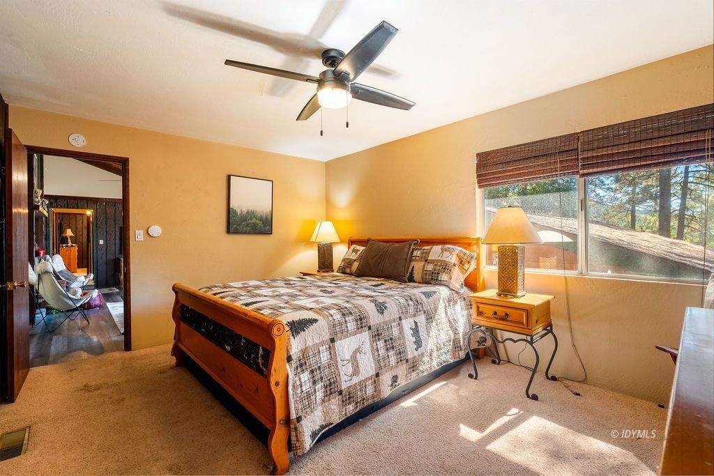 25580 Fir Street Idyllwild, CA 92549 - Photo 21 of 48 a bedroom with a bed and a large window