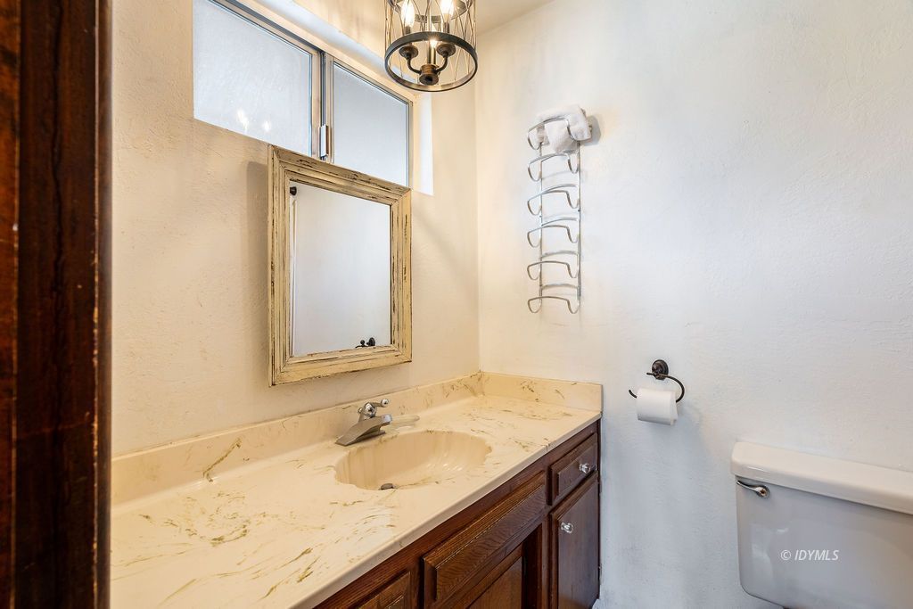 25580 Fir Street Idyllwild, CA 92549 - Photo 23 of 48 a bathroom with a granite countertop sink and a mirror