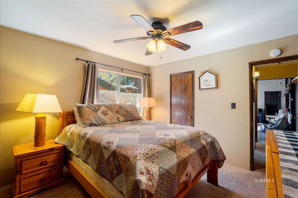 25580 Fir Street Idyllwild, CA 92549 - Photo 30 of 48 a bedroom with a bed and a mirror