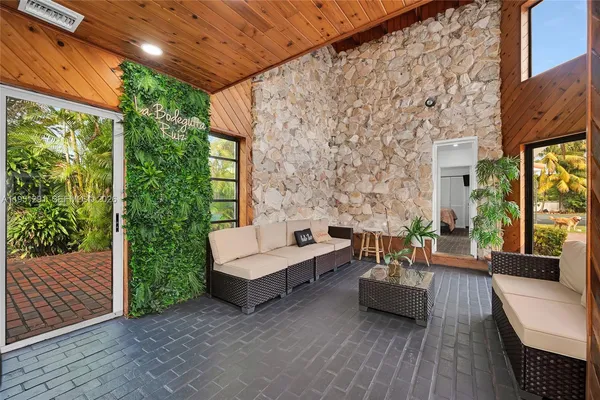 a balcony with furniture and a potted plant