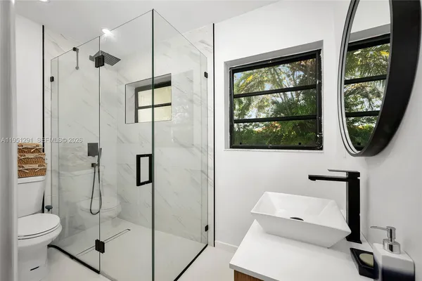 a bathroom with a toilet sink and shower