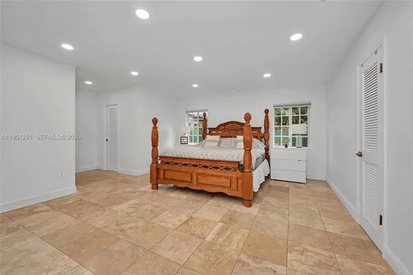 a spacious bedroom with a bed and a table