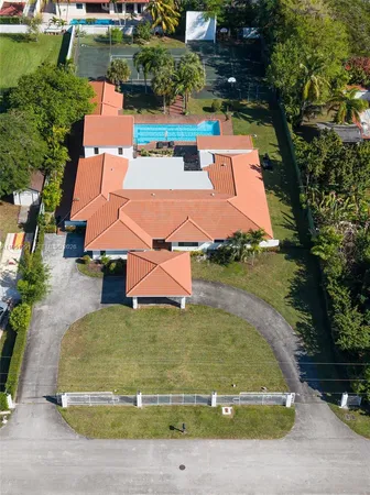 an aerial view of a house with yard swimming pool and outdoor seating