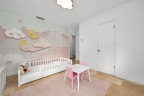 a view of a room with furniture and wooden floor