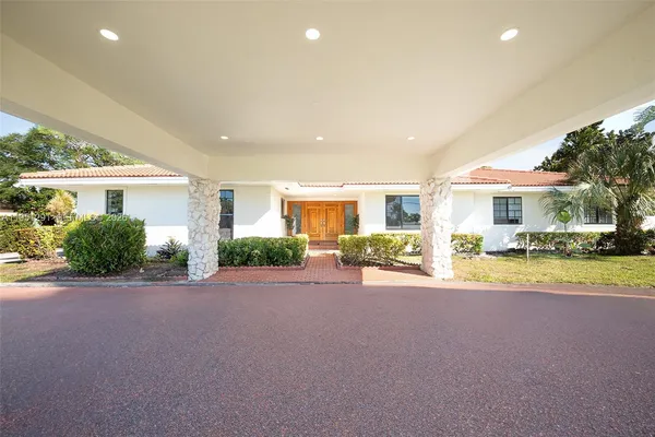 a view of a house with a patio and a yard