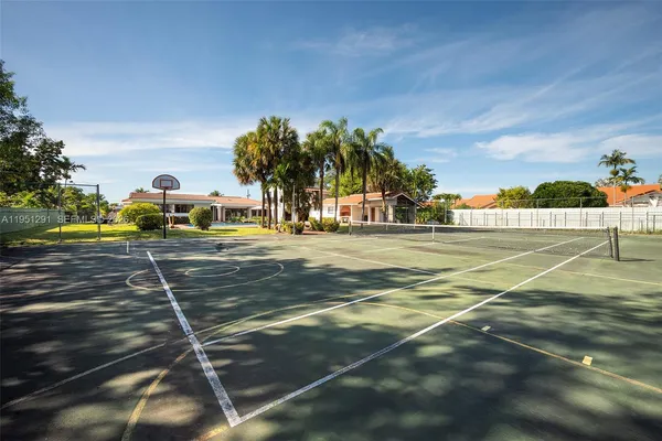 an aerial view of a house with a yard basket ball court and outdoor seating