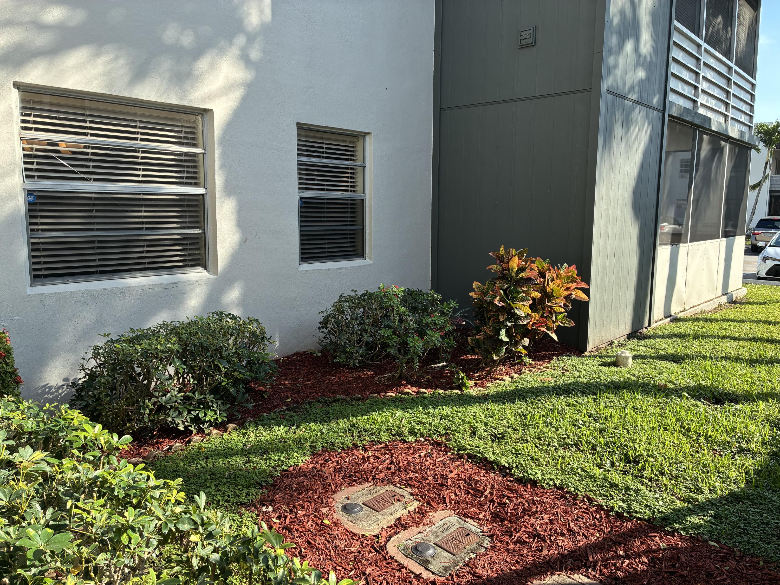 355 Normandy Lane Delray Beach, FL 33484 - Photo 17 of 33 a front view of a house with a yard and outdoor seating