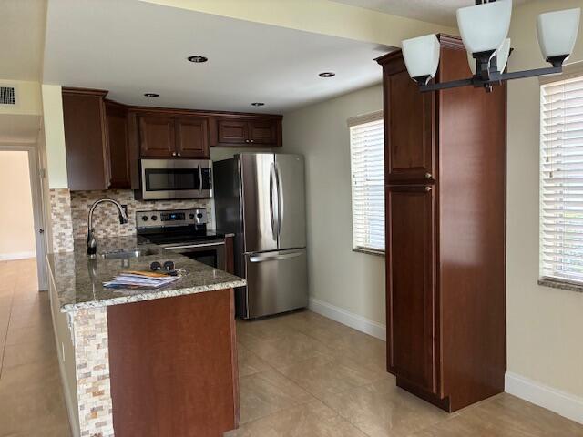 355 Normandy Lane Delray Beach, FL 33484 - Photo 3 of 33 a kitchen with stainless steel appliances a refrigerator and a stove top oven