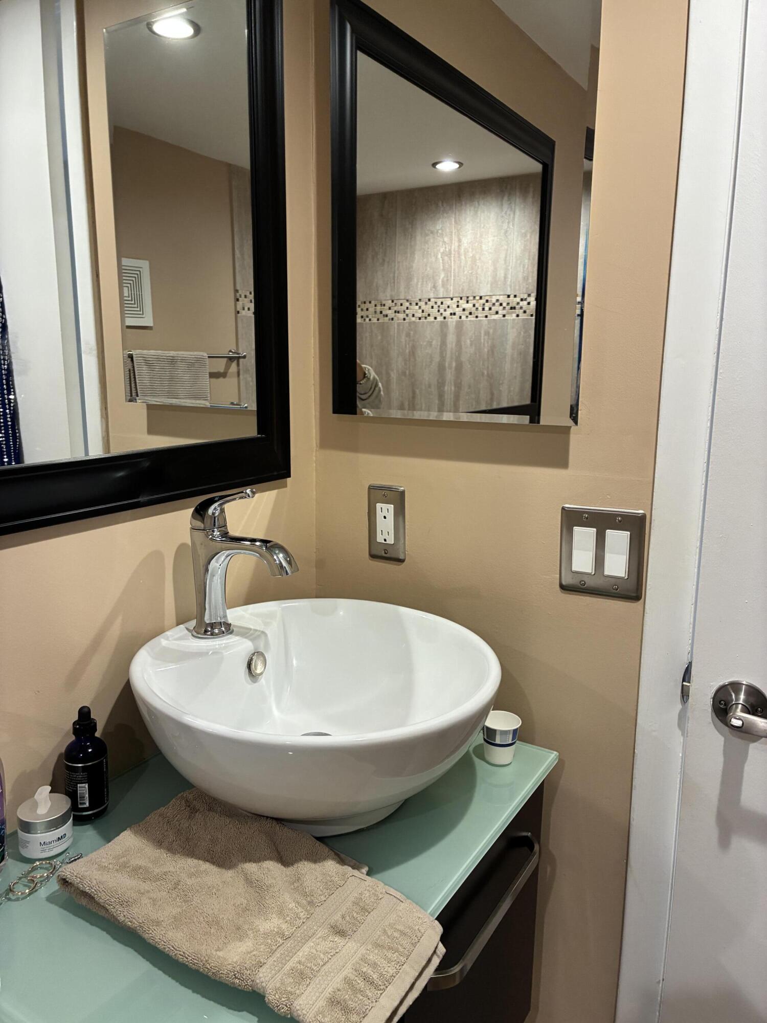 355 Normandy Lane Delray Beach, FL 33484 - Photo 9 of 33 a bathroom with a sink and a mirror