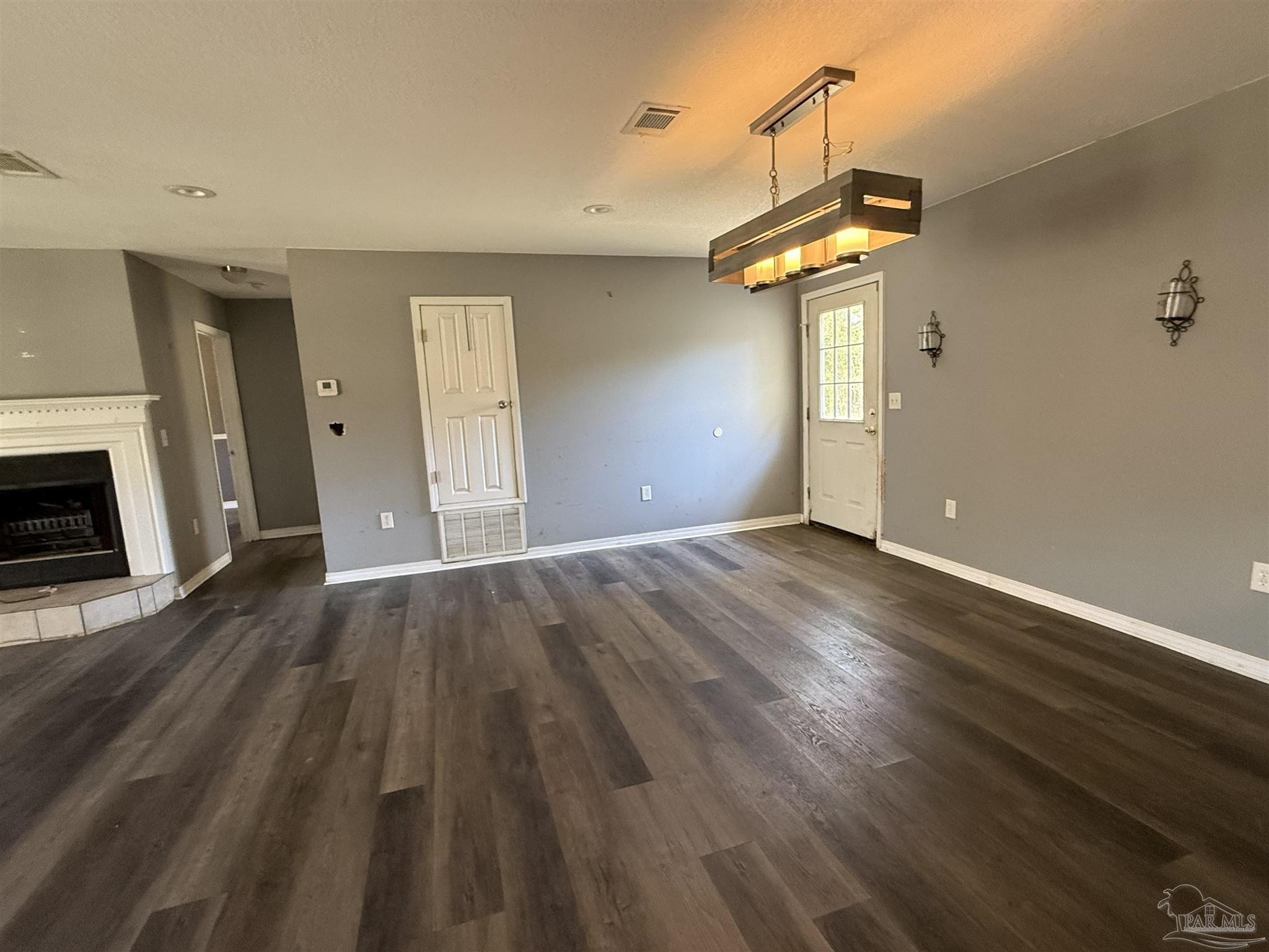 1009 Rachel Circle Cantonment, FL 32533 - Photo 3 of 11 a view of a livingroom with wooden floor and a ceiling fan