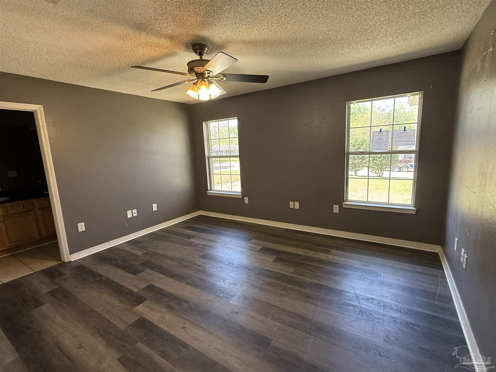 1009 Rachel Circle Cantonment, FL 32533 - Photo 5 of 11 a view of an empty room with wooden floor and a window