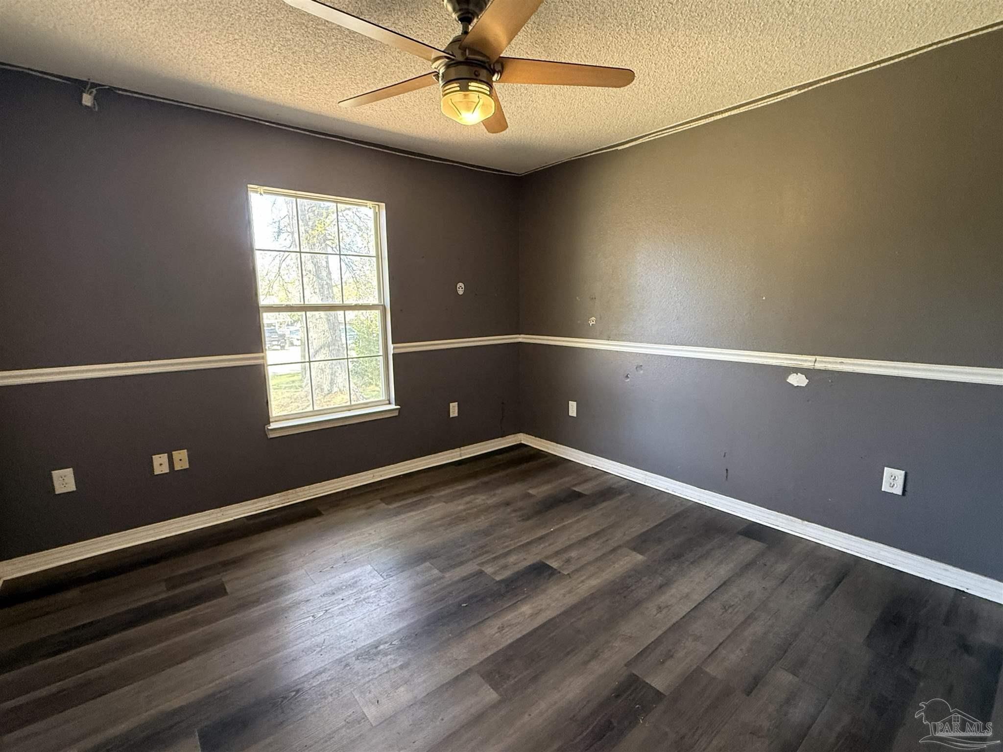 1009 Rachel Circle Cantonment, FL 32533 - Photo 7 of 11 an empty room with wooden floor and windows