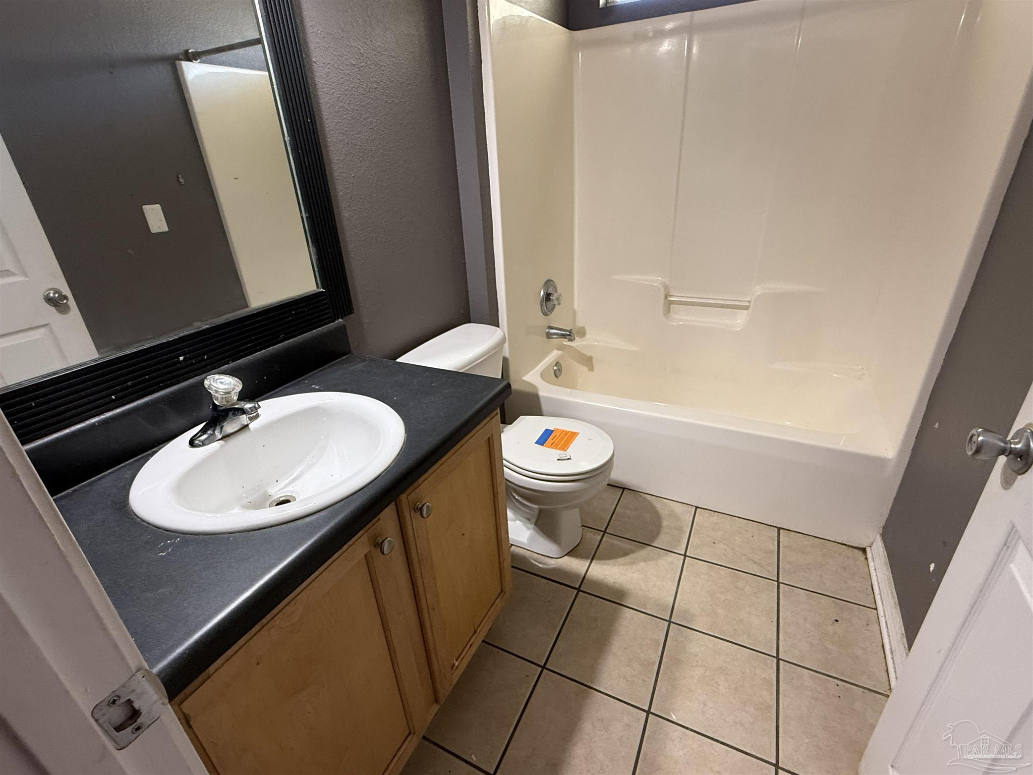 1009 Rachel Circle Cantonment, FL 32533 - Photo 8 of 11 a bathroom with a sink a toilet and mirror
