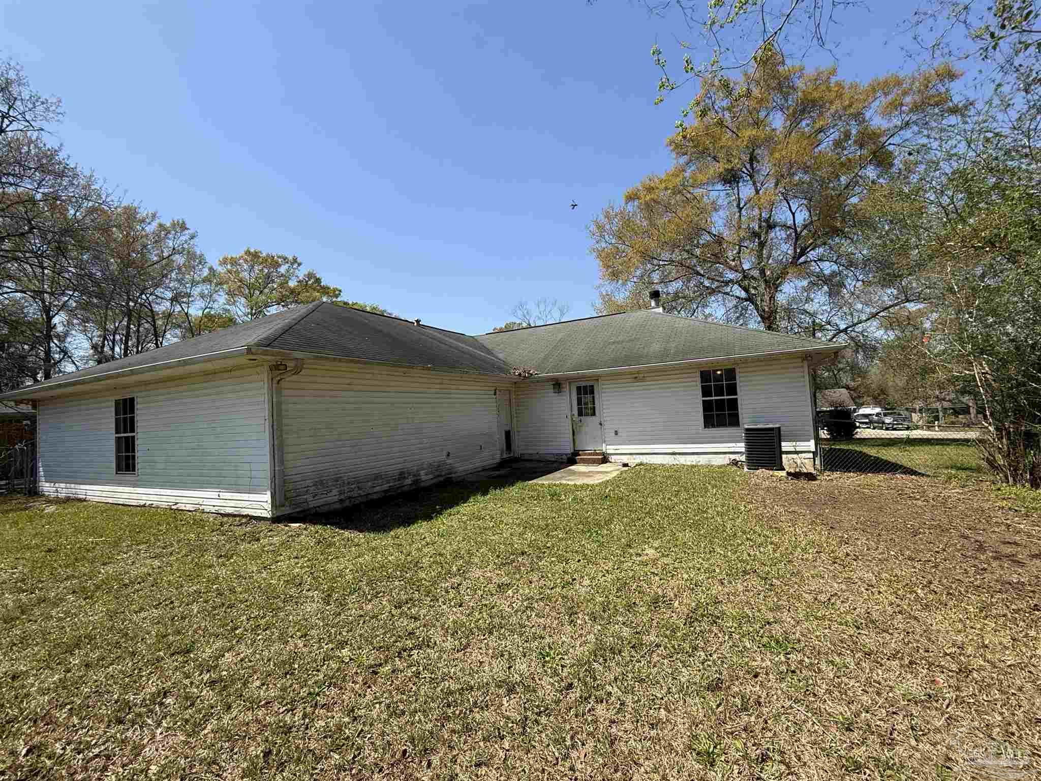 1009 Rachel Circle Cantonment, FL 32533 - Photo 10 of 11 a view of a house with a yard and garage