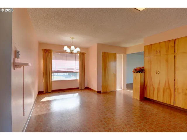 a view of a kitchen with a refrigerator a ceiling fan and wooden floor