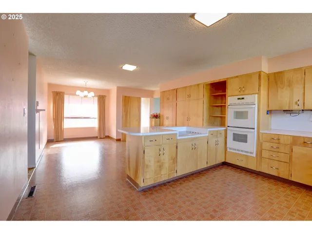 a kitchen with cabinets a sink and wooden floors