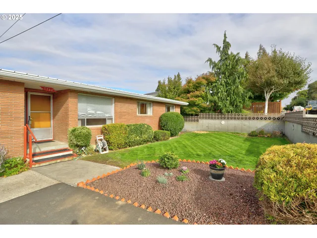 a front view of house with yard and green space