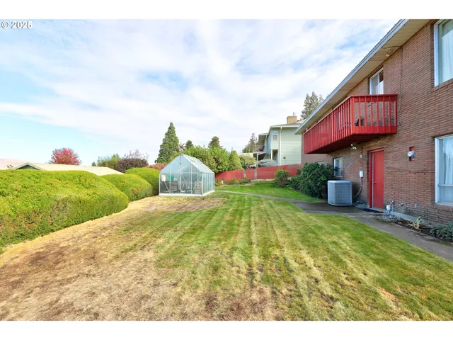 a view of a house with pool and a yard