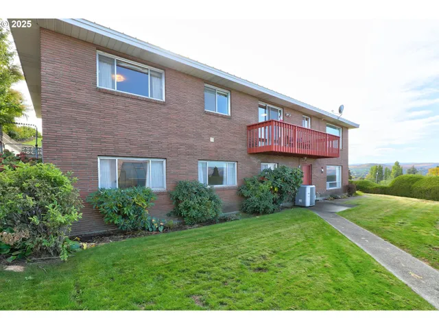 a view of a brick building with a yard