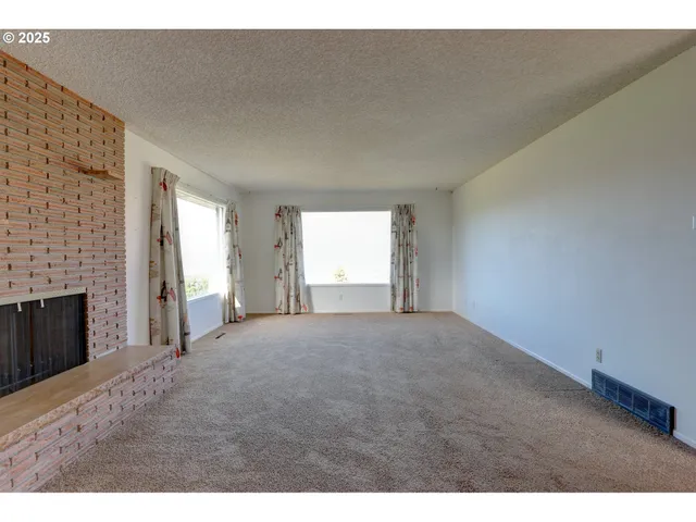 a view of empty room with a fireplace