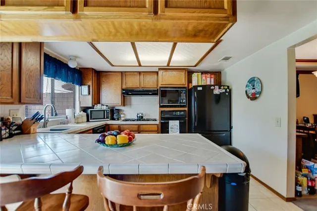a kitchen with stainless steel appliances wooden floor dining table and chairs
