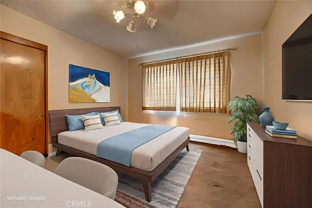 a bedroom with bed and a flat screen tv