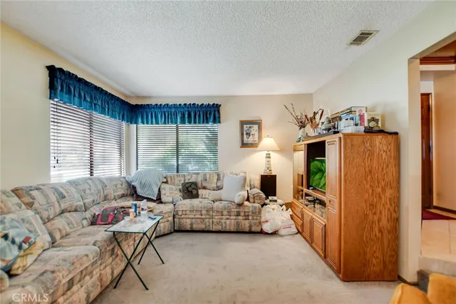 a living room with furniture fireplace and a flat screen tv
