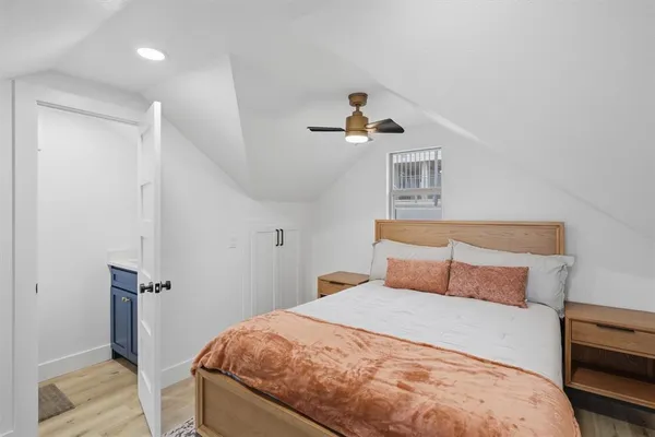 a bedroom with a bed and a window