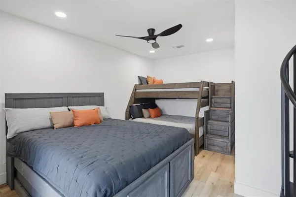 a bedroom with a bed and a ceiling fan
