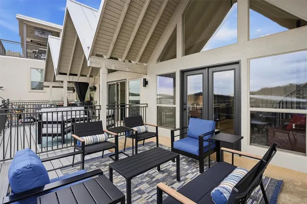 a view of a chairs and table in the balcony