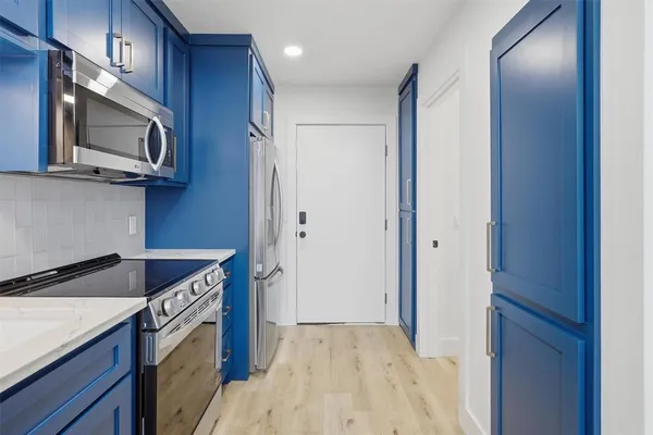a kitchen with a stove microwave and refrigerator