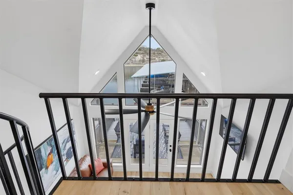 a view of staircase with railing and white walls