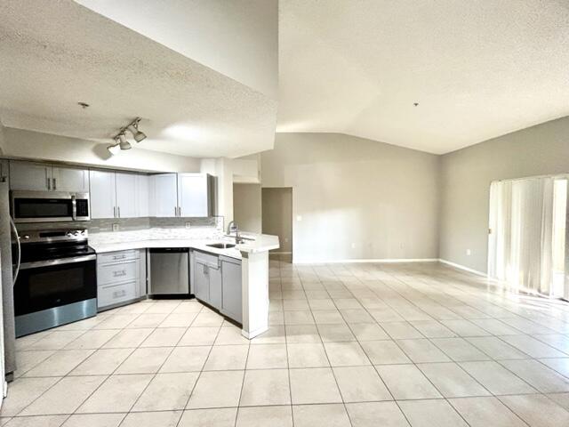 741 North Pine Island Road, Unit 303 Plantation, FL 33324 - Photo 5 of 32 a large kitchen with a stove a sink dishwasher and a refrigerator