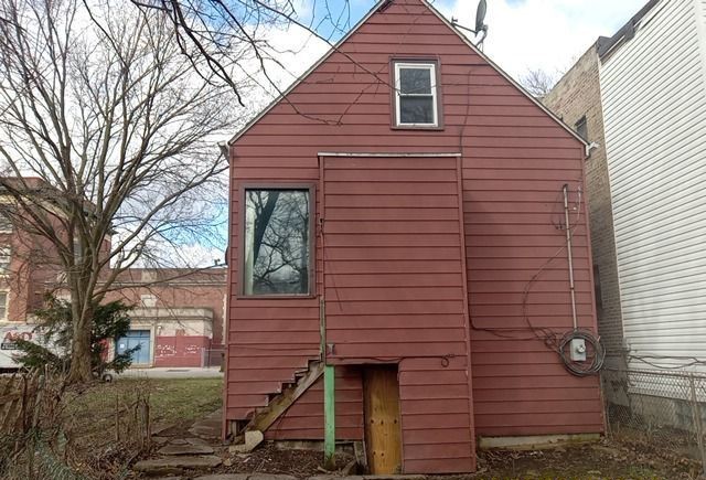 6531 South May Street Chicago, IL 60621 - Photo 12 of 12 a view of a house with a yard and wooden fence
