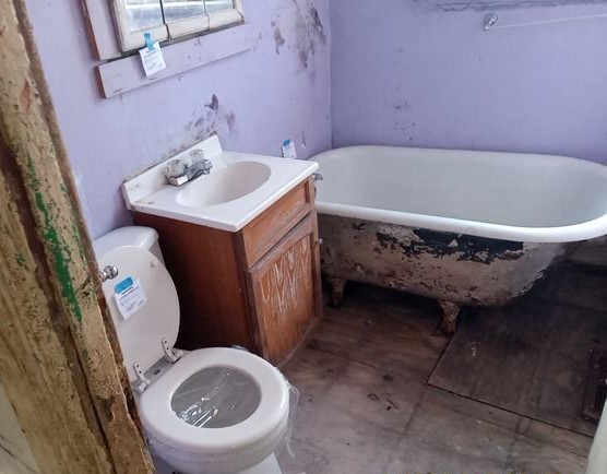 6531 South May Street Chicago, IL 60621 - Photo 9 of 12 a bathroom with a sink and toilet