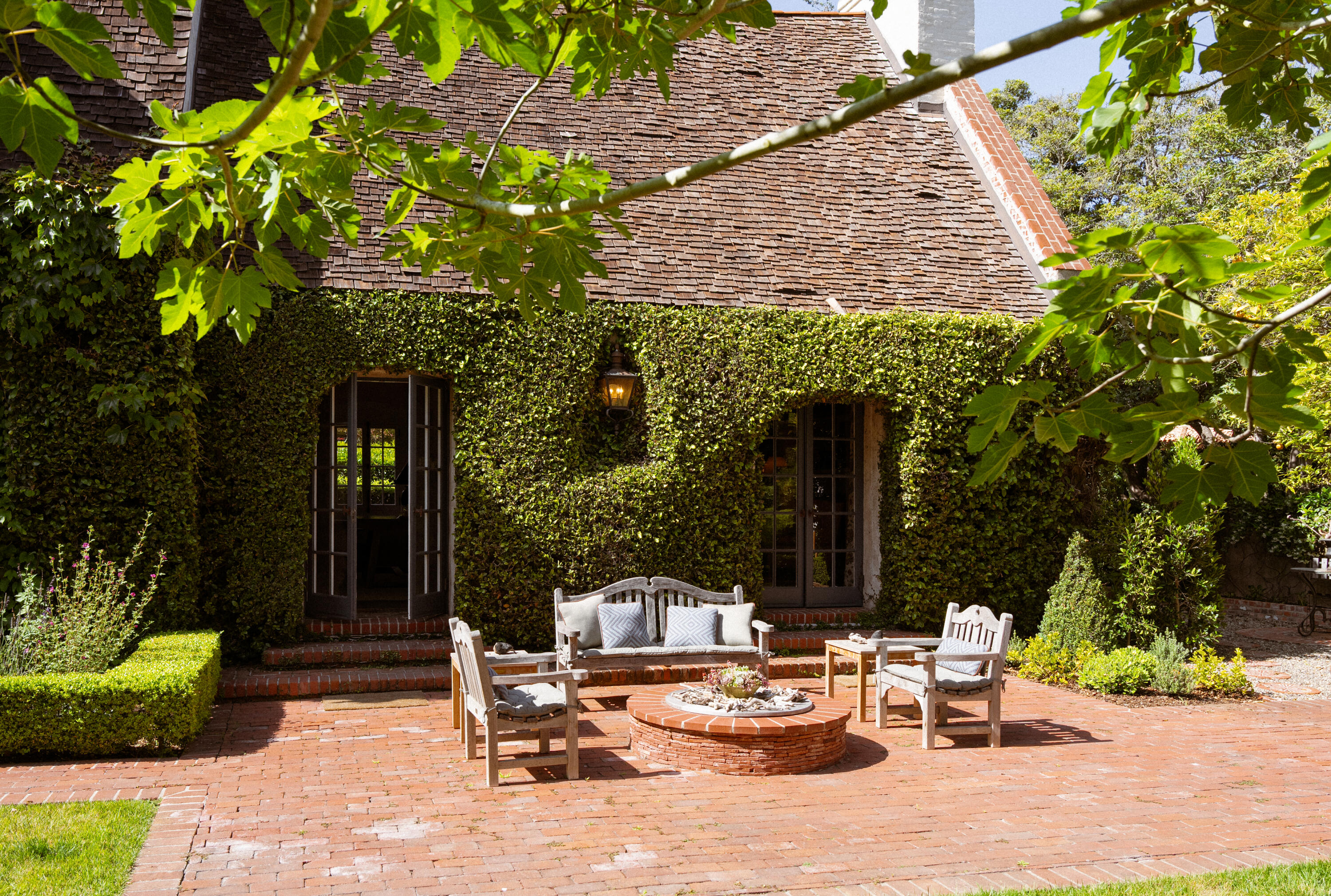 175 Miramar Avenue Montecito, CA 93108 - Photo 27 of 33 a view of a chair and tables in the patio in front of a house