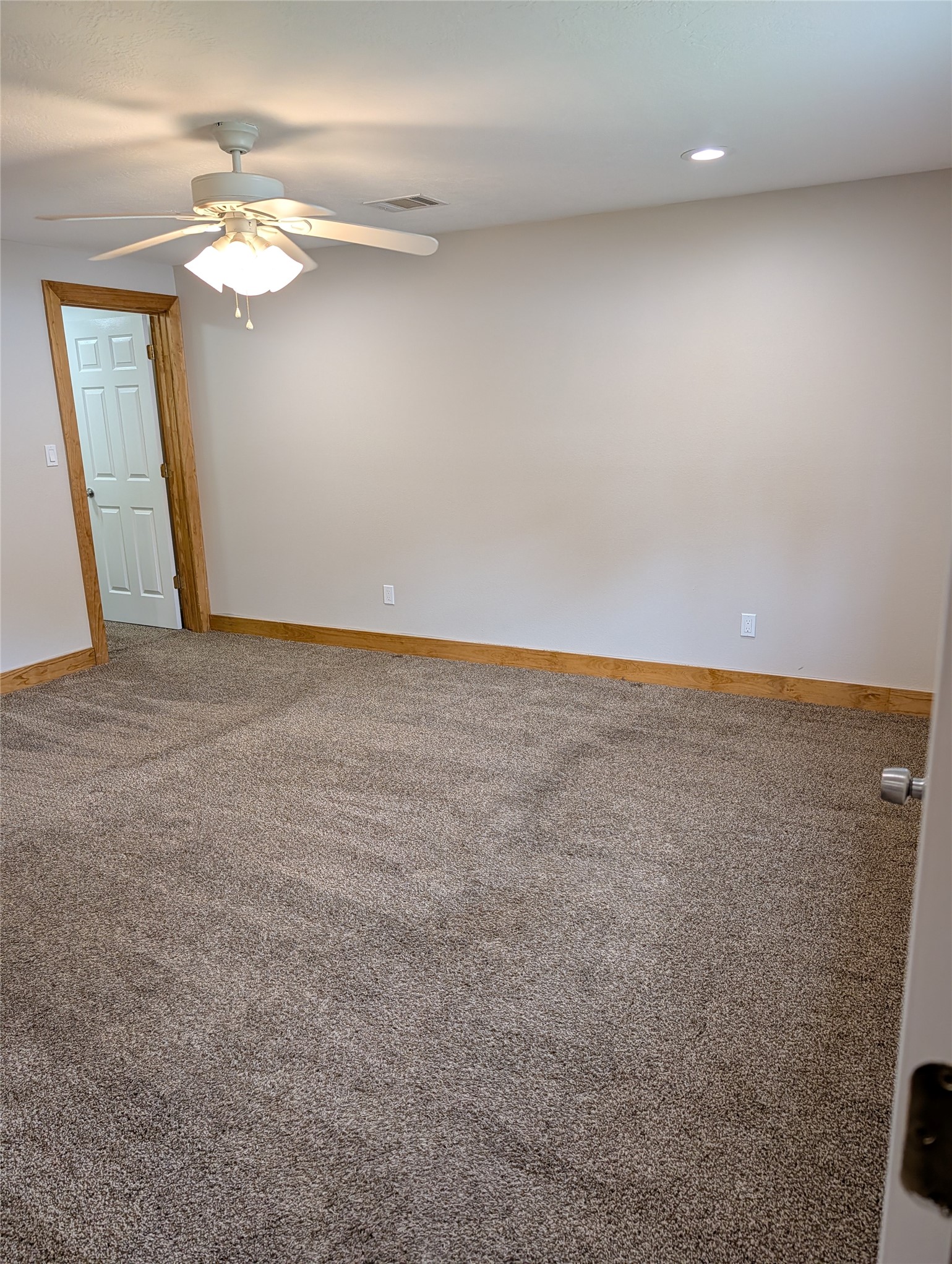 16 Walnut Lane Huntsville, TX 77320 - Photo 14 of 15 an empty room with a chandelier fan and windows