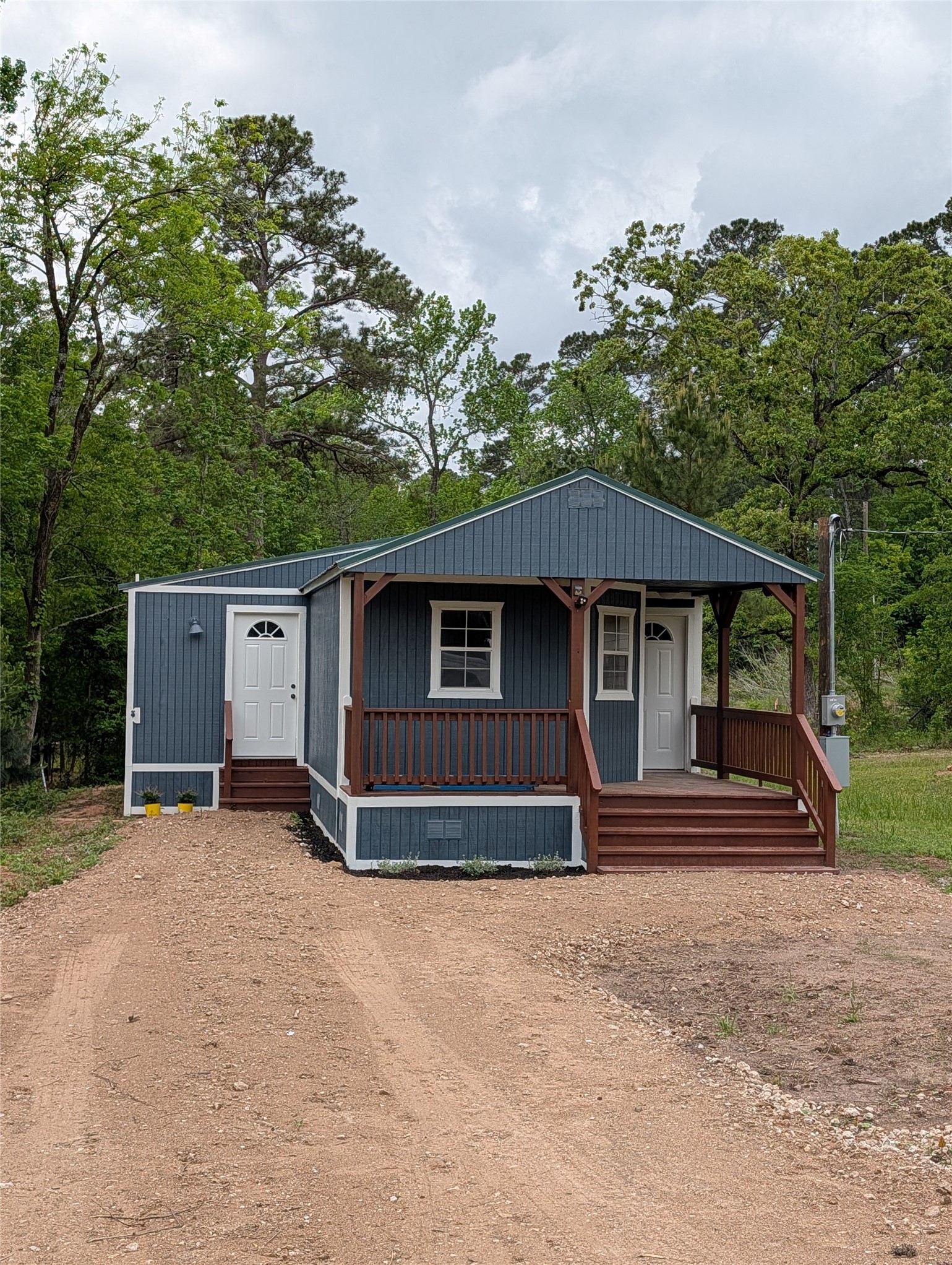 16 Walnut Lane Huntsville, TX 77320 - Photo 2 of 15 a house with trees in the background