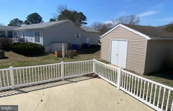 a view of a house with wooden fence