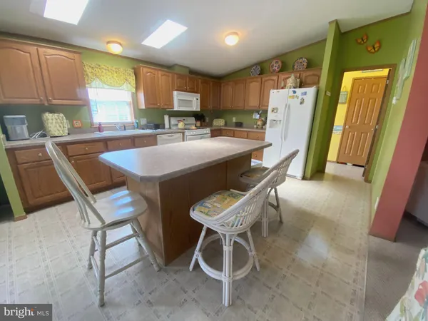 a kitchen with a table chairs refrigerator and cabinets