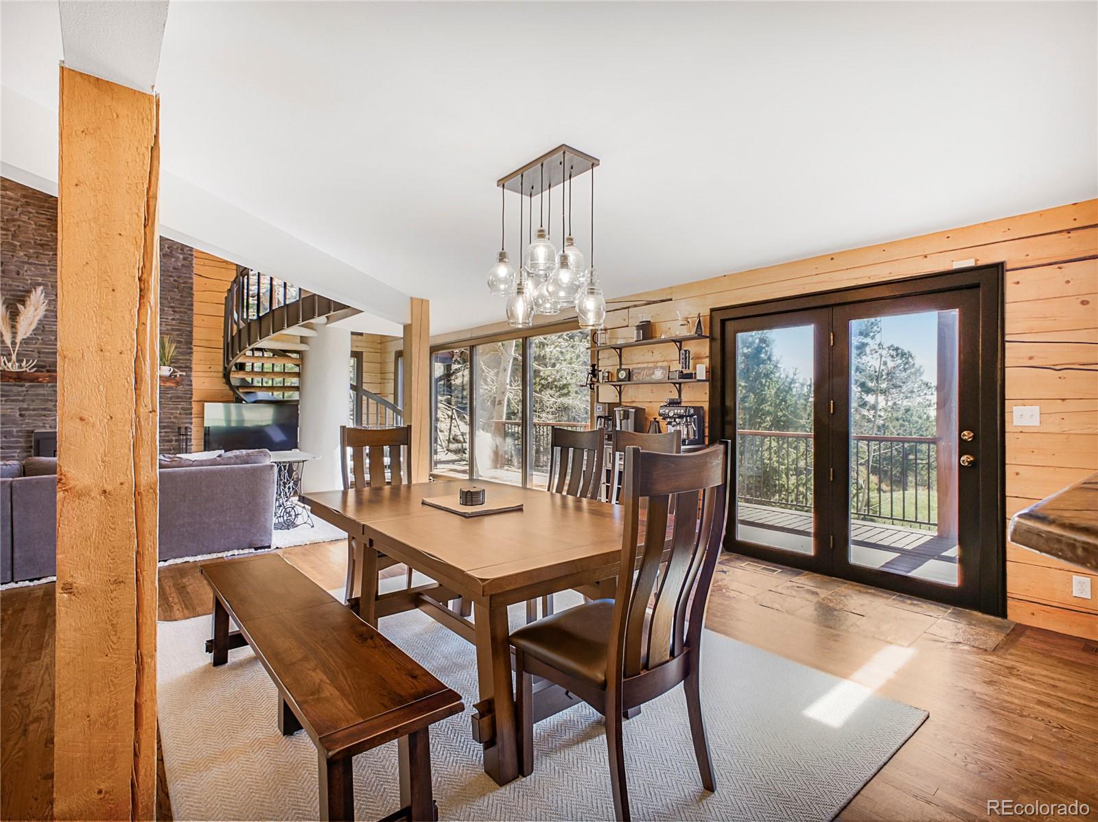 24 Pine Valley Road Evergreen, CO 80439 - Photo 11 of 50 a dining room with furniture a chandelier and wooden floor