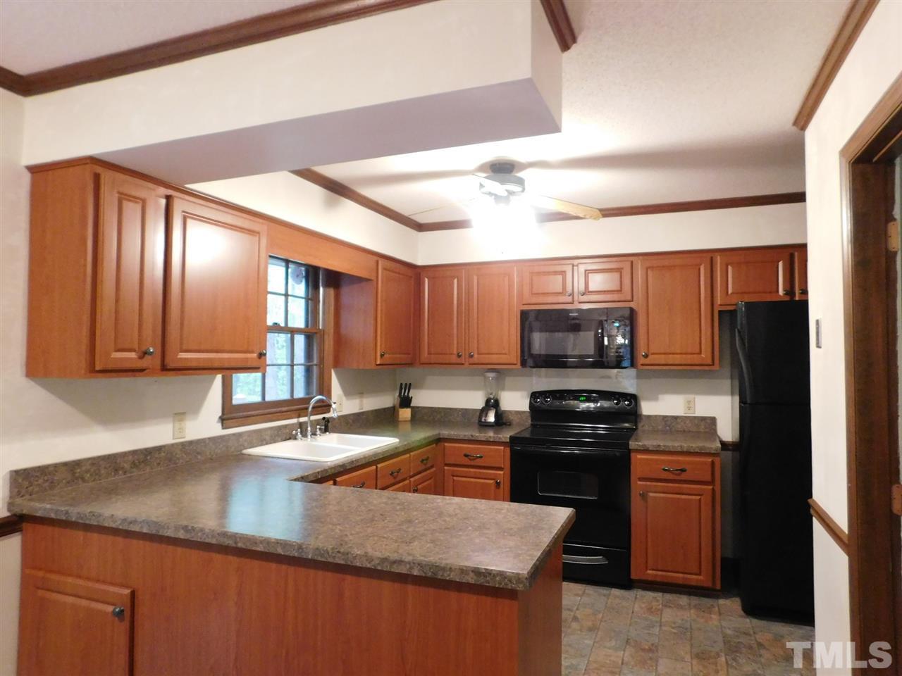 3224 Brennan Drive Raleigh, NC 27613 - Photo 12 of 22 a kitchen with a stove a sink and a microwave