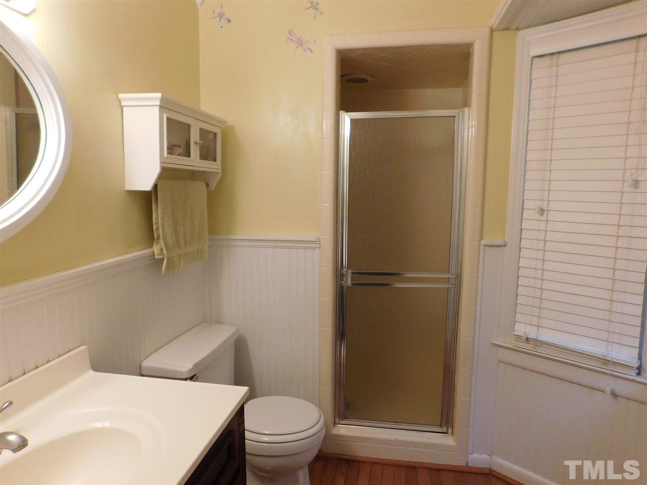 3224 Brennan Drive Raleigh, NC 27613 - Photo 14 of 22 a white toilet sitting next to a bathroom sink