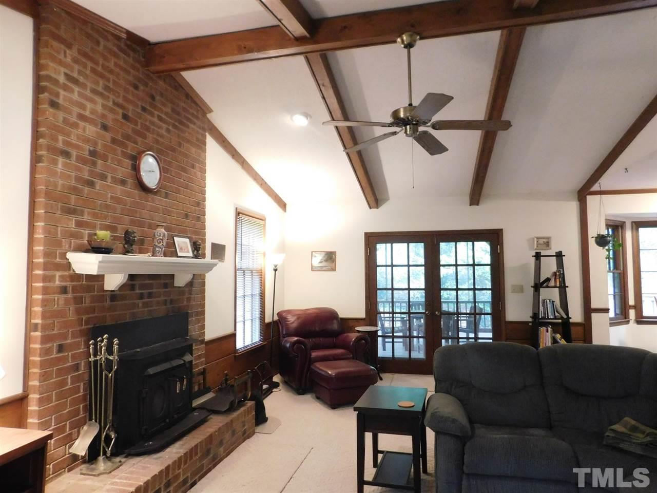 3224 Brennan Drive Raleigh, NC 27613 - Photo 7 of 22 a living room with furniture a ceiling fan and a rug