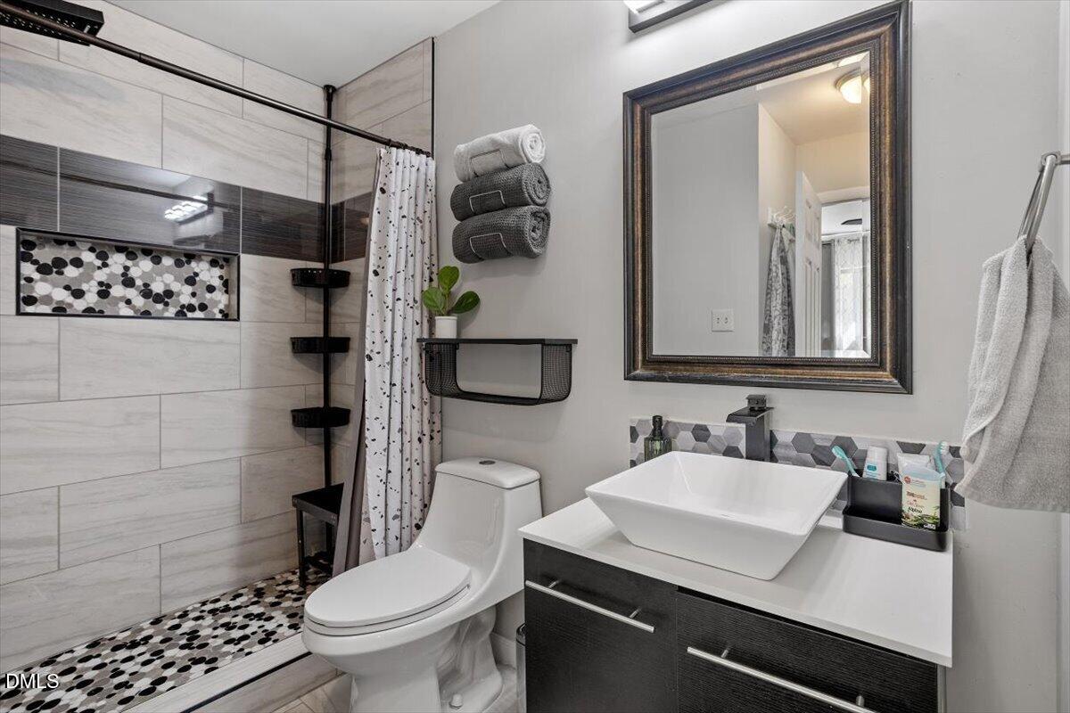 5045 Tall Pines Court Raleigh, NC 27609 - Photo 24 of 37 a bathroom with a sink toilet and shower