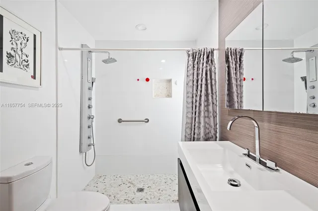 a bathroom with a sink toilet and shower