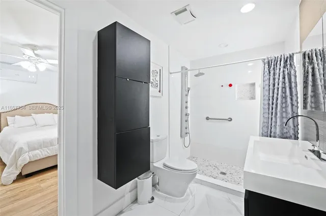 a bathroom with a sink toilet and shower