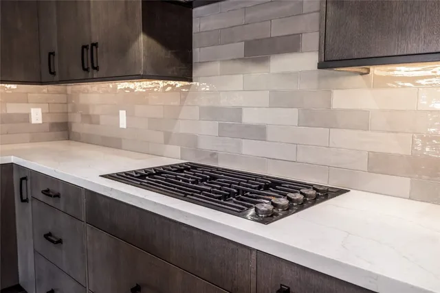 a stove top oven sitting inside of a kitchen